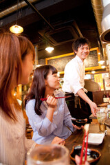 料理を運ぶ店員と女性客