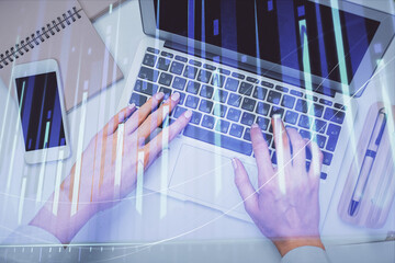 Fototapeta na wymiar Double exposure of woman hands working on computer and forex graph hologram drawing. Top View. Financial analysis concept.