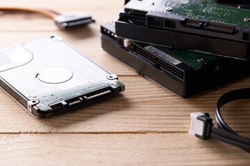 data storage hardware for desktop and laptop computers. backup data technology concept. stack of hard drive disc over wooden background. information recovery conceptual