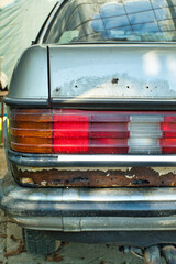 An old-timer car heavily damaged by rust and corrosion