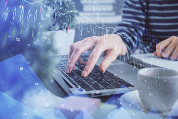 Double exposure of woman hands typing on computer and forex chart hologram drawing. Stock market invest concept.