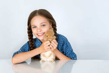 Happy little child girl with cute rabbit. Portrait of kid with pet.