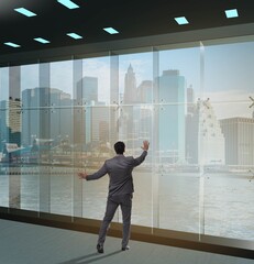 Fototapeta premium Businessman in front of office window thinking of new challenges