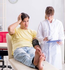 Young doctor checking patients blood pressure