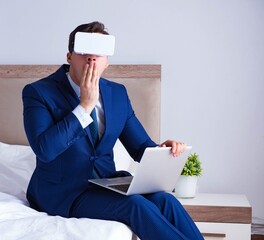 Businessman wearing a virtual reality headset in the bedroom