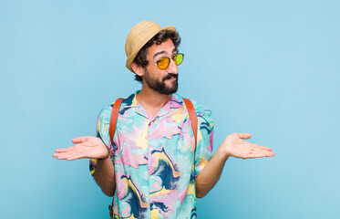 young bearded tourist man feeling puzzled and confused, unsure about the correct answer or...