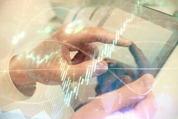 Multi exposure of man's hands holding and using a phone and financial chart drawing. Market analysis concept.