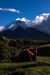 people camping in front of a cotopaxi mountain