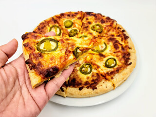 Homemade pizza ; Jalapenos pickle on cheese pizza crust on white plate in white background