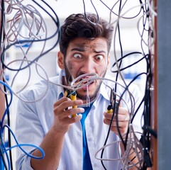 Computer repairman working on repairing network in IT workshop