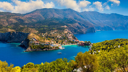 Assos village in Kefalonia, Greece. Turquoise colored bay in Mediterranean sea with beautiful colorful houses in Assos village in Kefalonia, Greece, Ionian island, Cephalonia, Assos village.