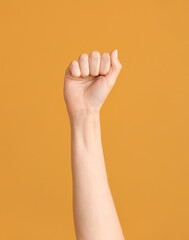 Hand showing letter A on color background. Sign language alphabet