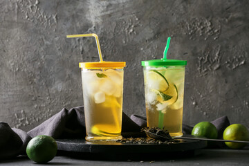 Glasses of tasty cold ice tea on dark background