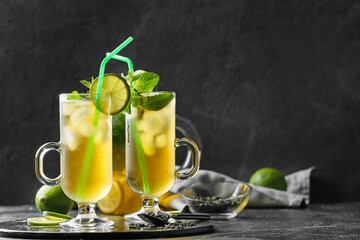 Cups of tasty cold ice tea on table