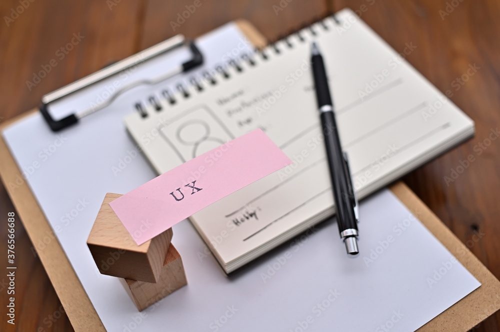 Aufkleber a note with the user's persona written on it is placed on a clipboard along with a pen. a sticky not