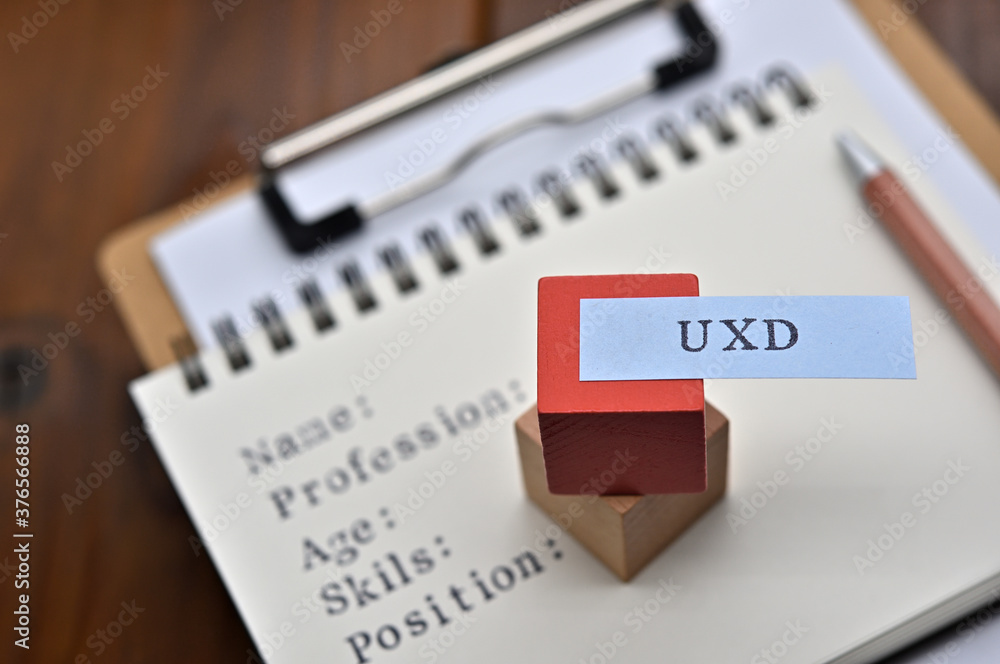 Poster a note with the user's persona written on it is placed on a clipboard. a sticky note stamped with 