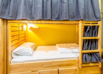 Fototapeta na wymiar Hostel dormitory beds arranged in room