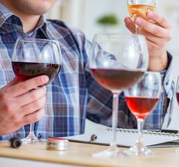 Professional sommelier tasting red wine