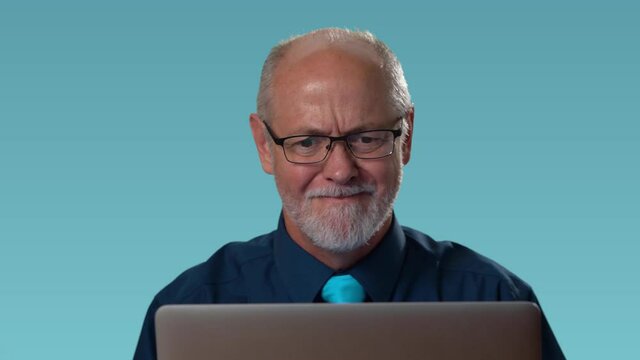 Funny business man has problem on computer, tears off glasses and furious in rage and anger yells at his computer. Closeup portrait on blue background.