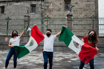 Mexican people with flag and face mask in mexican independence day in Mexico