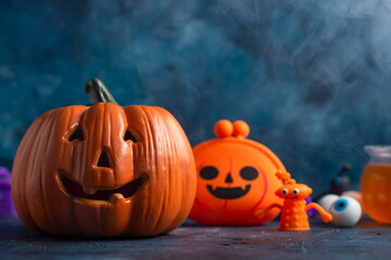 Halloween pumpkin on a blue background,. Space for design, festive mood, with children's accessories and toys