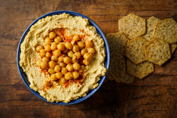 Hummus in a bowl with crackers