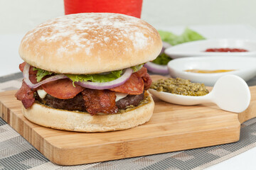 Tasty Italian Burger With Cheese, Meat, Bacon, And Slices Of Salami.