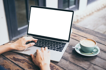 Fototapeta premium computer mockup blank screen.hand woman work using laptop with white background for advertising,contact business search information on desk at coffee shop.marketing and creative design