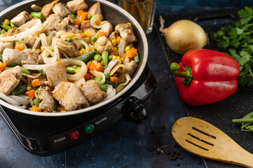 Roasting meat, pork with vegetables, on the background of fresh vegetables, cooking and cooking