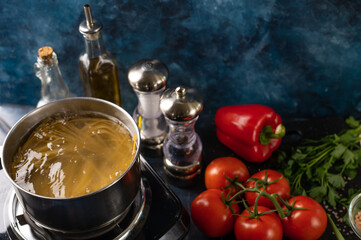 Italian pasta is cooked on a background of fresh vegetables