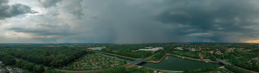 panoramic photo from the drone, river, bridge, houses, crane in the rain