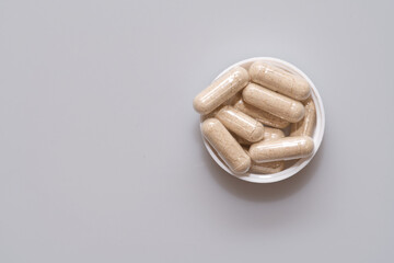 vegetarian capsules laid on white table isolated © avrezn
