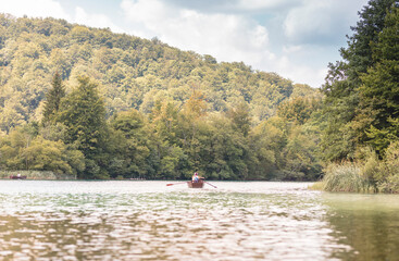 Natural idyllic amazing holiday at plitvice lakes national park, rowboat travel in beautiful Croatia waterfalls
