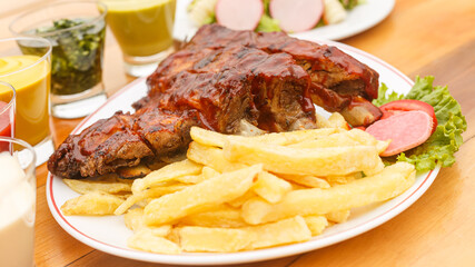 barbecue rib with french fries and salad - peruvian food