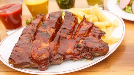barbecue rib with french fries and salad - peruvian food