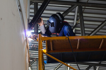 Metal workers use manual labor. Skilled welder.  Welder is welding the steel in the factory. welder Industrial automotive part in factory.