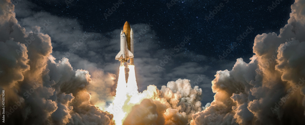 Wall mural spaceship takes off into the night sky on a mission. rocket starts into space concept.elements of th