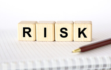 business concept. word RISK on cubes on light background