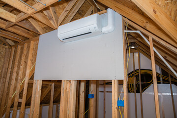Mini-split ductless air conditioning unit installed in unfinished room