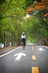 Sportswoman ride bike on road, Work life balance concept and stay active with relaxation idea