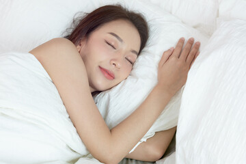 Fototapeta na wymiar Asian women sleeping and sweet dream on white bed in bedroom