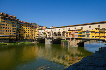 Fototapeta na wymiar Reflection of Ponte Vecchio in Arno River in Florence, Italy