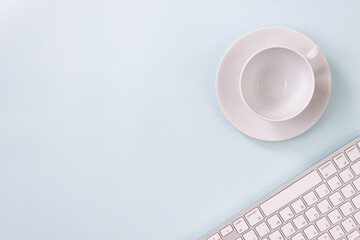 Coffee Cup and Pen and Computer Keyboard on Modern Clean Creative Office Desk or Office Table on Top View or Flat Lay. Blue Workspace Minimalist Background and Office Supplies