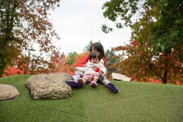 sisters playing on the park having fun 