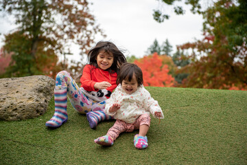 sisters playing on the park having fun 
