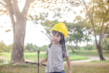 A close-up view of a cute Asian girl. Who are simulating learning outside of the classroom, event planning, designing on the mechanic