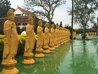 statues in a buddhist temple on a rainy day