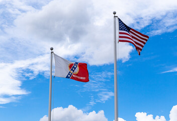 Fototapeta premium City of Montgomery flag and United States of America flag waving against blue sky
