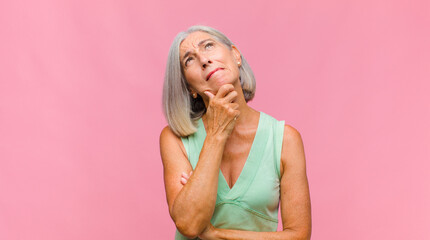middle age pretty woman feeling proud, arrogant and confident, looking satisfied and successful,...