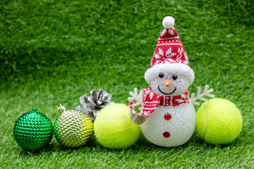 Tennis Halloween with tennis ball and pumpkin on green grass
